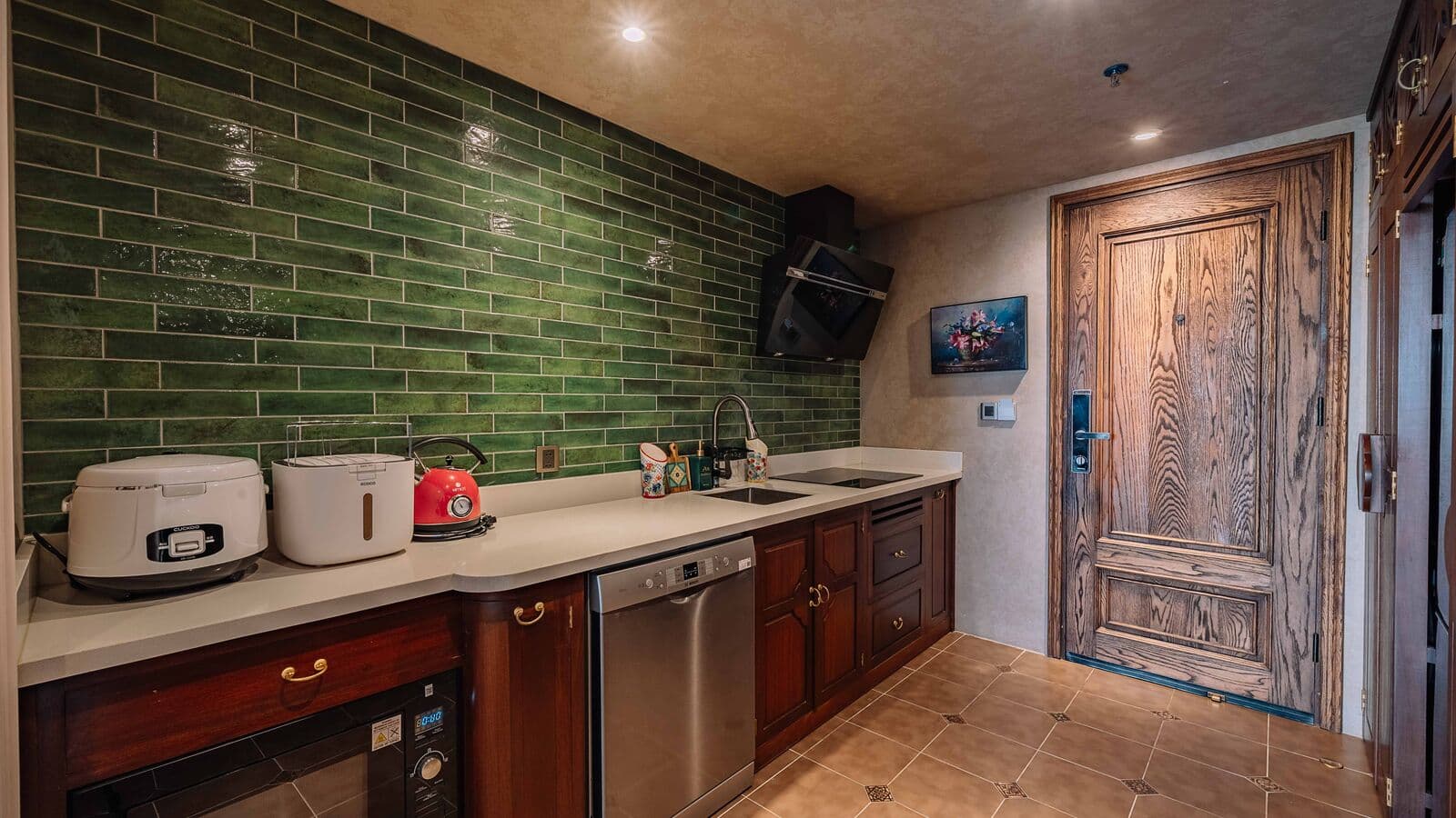 Kitchen with green tiles and built-in appliances
